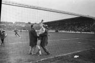 Travelling Ajax fans invade the pitch and embrace keeper Gert Bals after Ajax qualify on aggregate for the European Cup Final